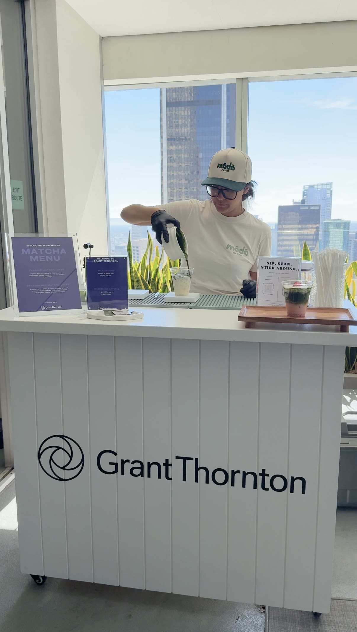 Matcha poured to order behind the Grant Thornton bar with the downtown Los Angeles skyline behind
